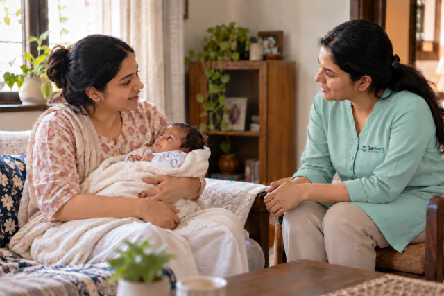A mother with her baby and a home-care professional